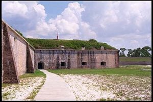 The bastions are structures which extend into the ditch, allowing guns to fire at an enemy who is trying to scale the walls of the fort. Again, the gun embrasures you see were originally several feet higher above the ditch than at present, making them much more difficult for an enemy to attack.